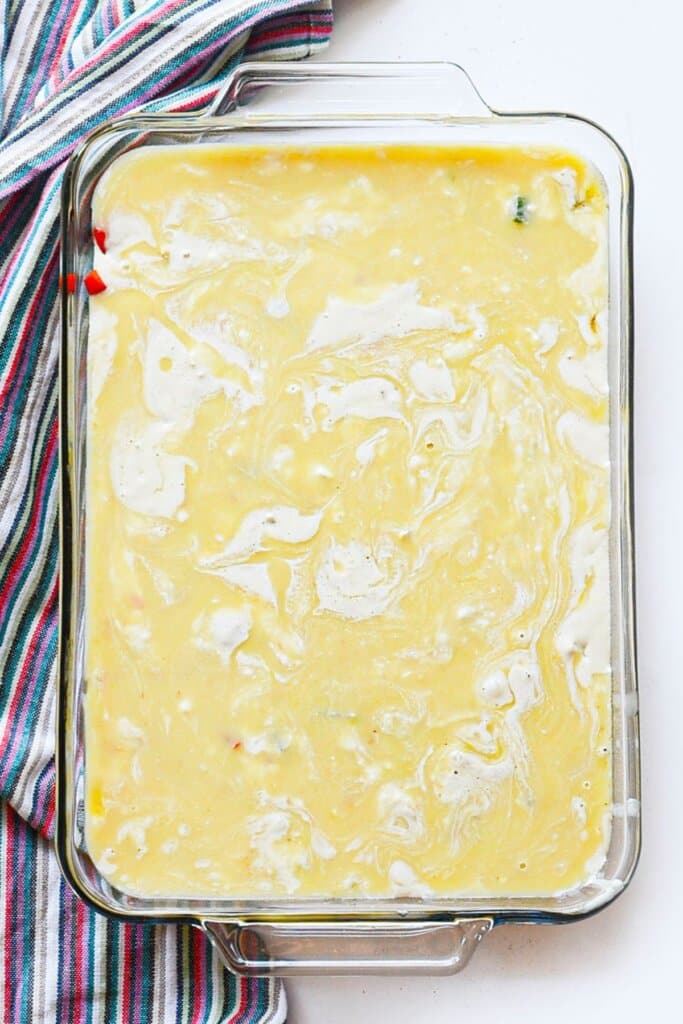 Cream soup poured on top of ingredients in a baking dish.
