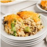 Chicken Broccoli and Rice Casserole Serving of chicken broccoli and rice casserole on a stack of white plates.