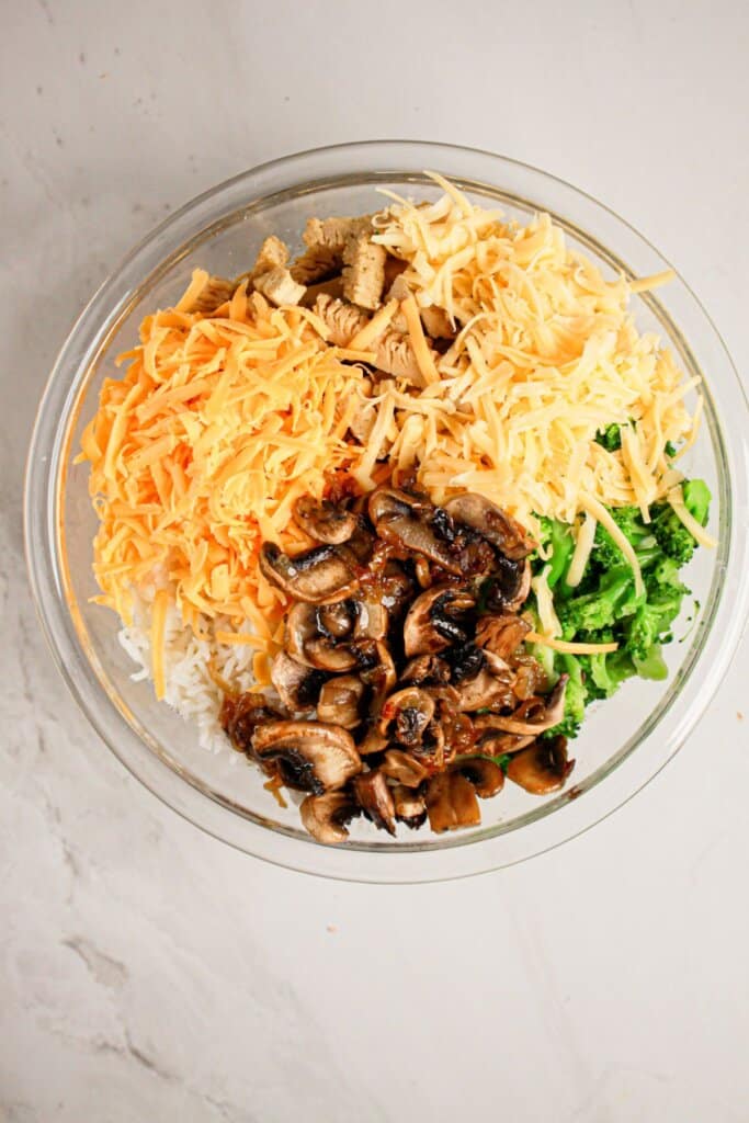 Ingredients being mixed in a large glass bowl.