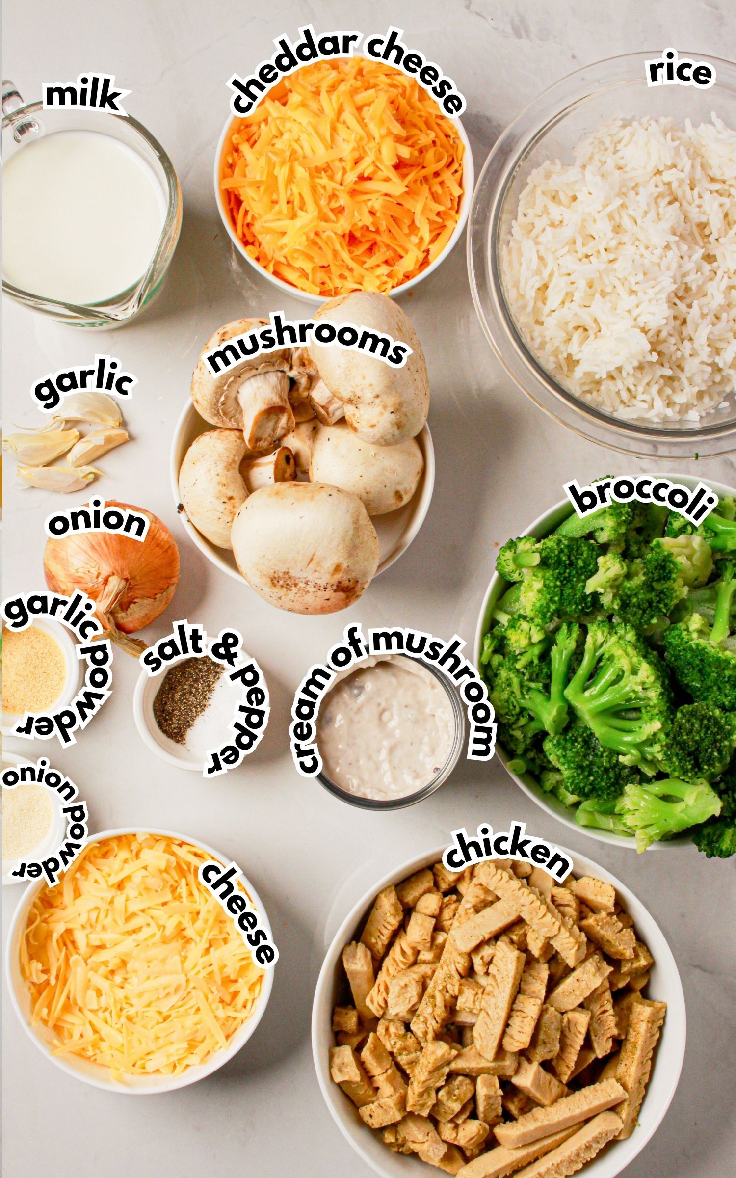 Bowls of ingredients labelled with text on a counter. 
