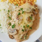 White plate with chicken gloria, white rice, and corn.