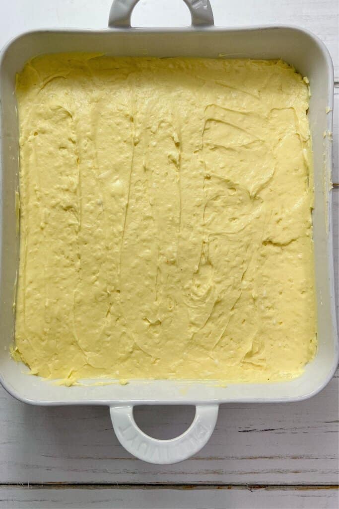 Batter being spread in a baking dish.