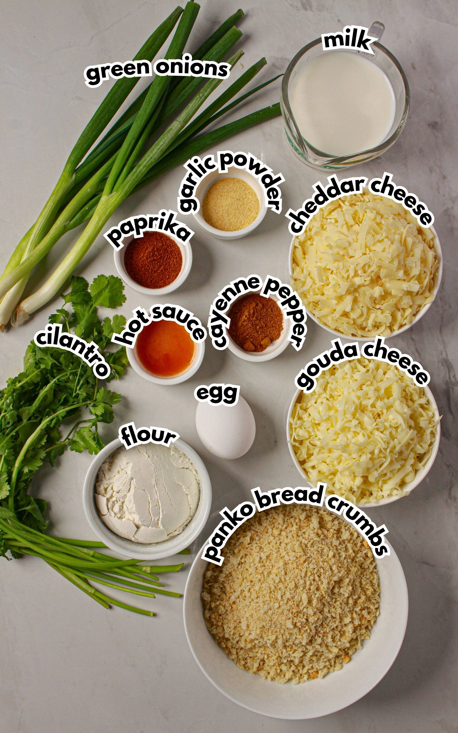 Bowls of ingredients labelled with text on a counter.