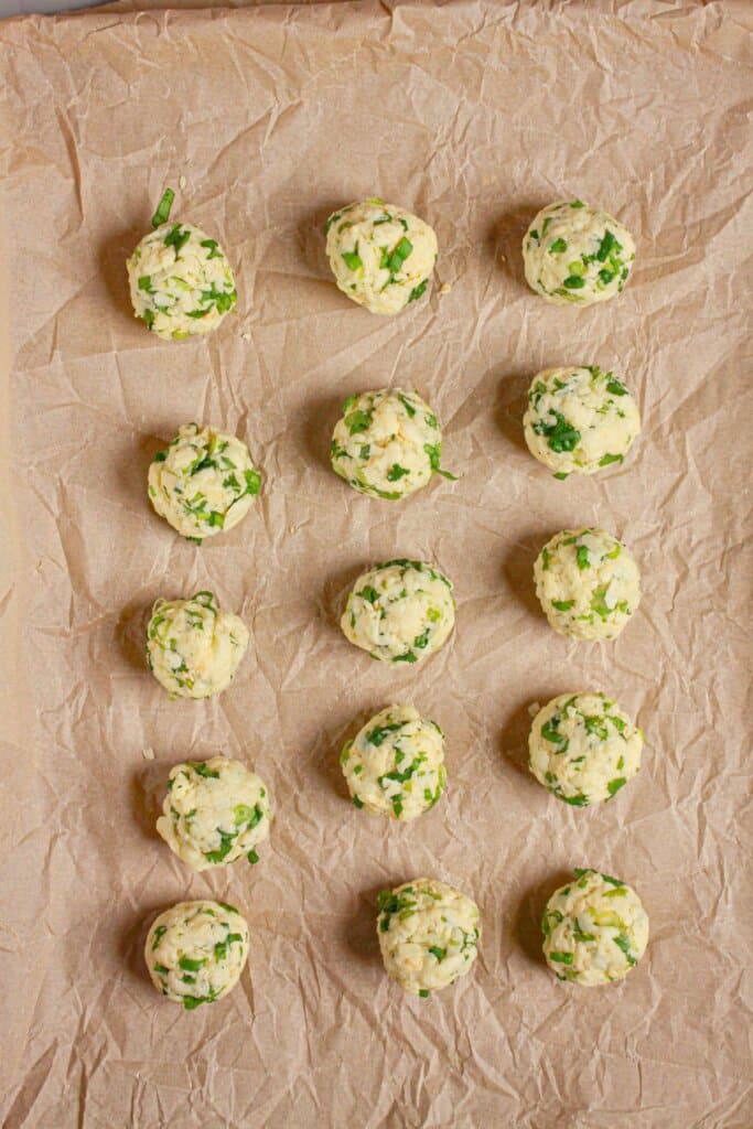 Balls on a parchment-lined baking sheet.