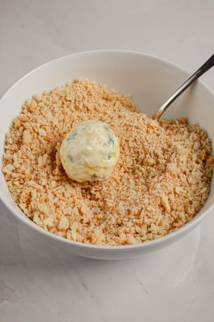 Ball being rolled in bread crumbs.