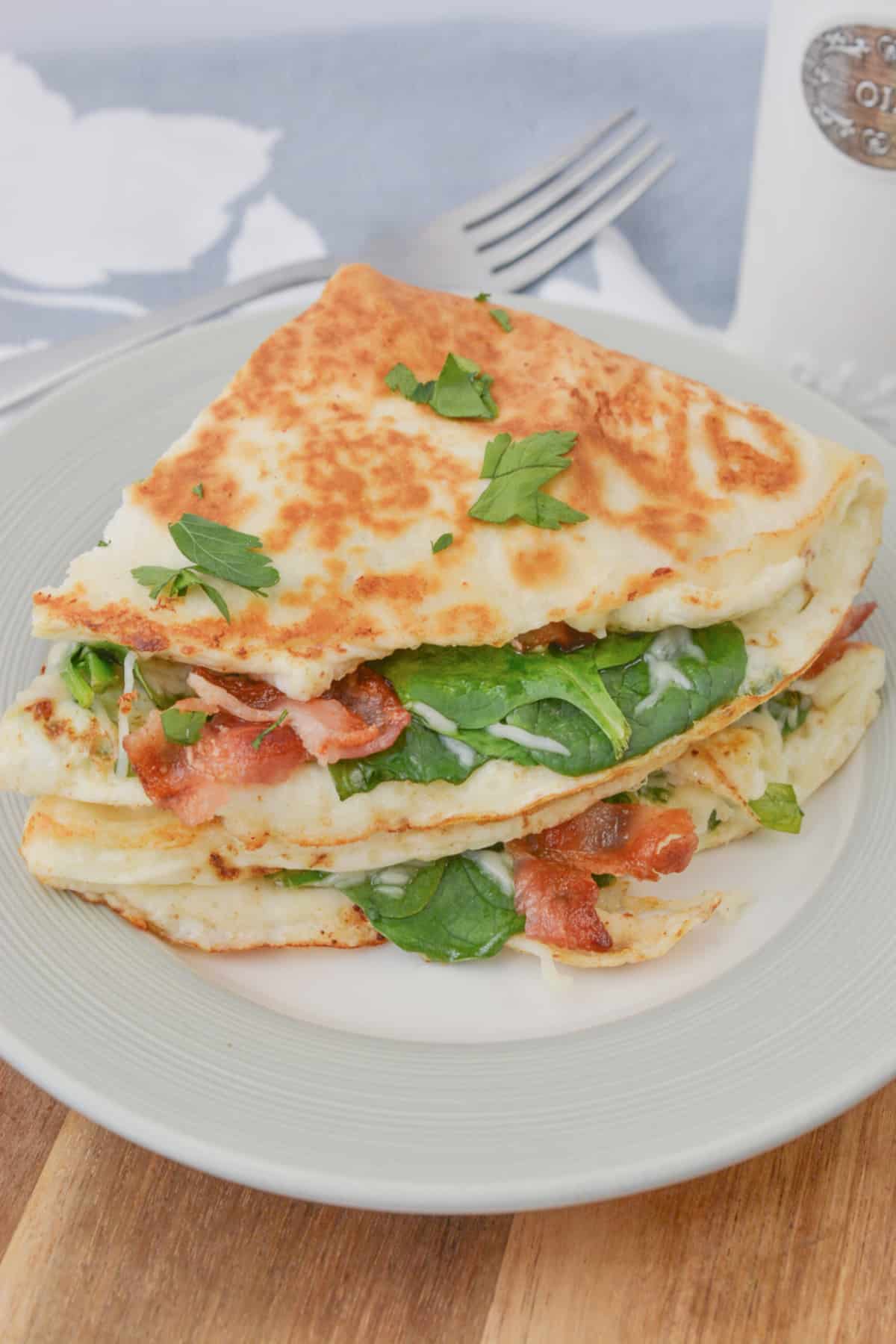 Two quesadillas stacked on a white plate.