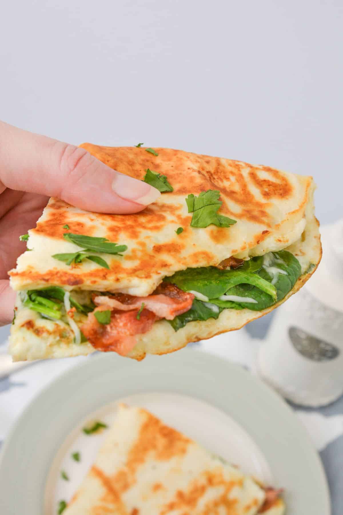 Quesadilla held in the air.