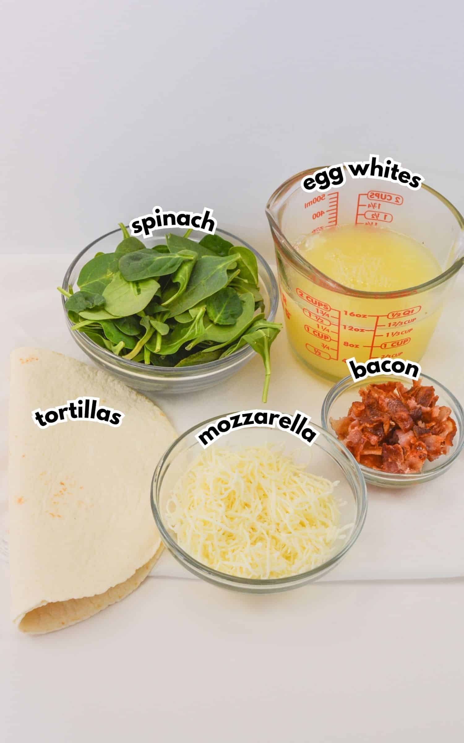Bowls of ingredients on a counter labelled with text.