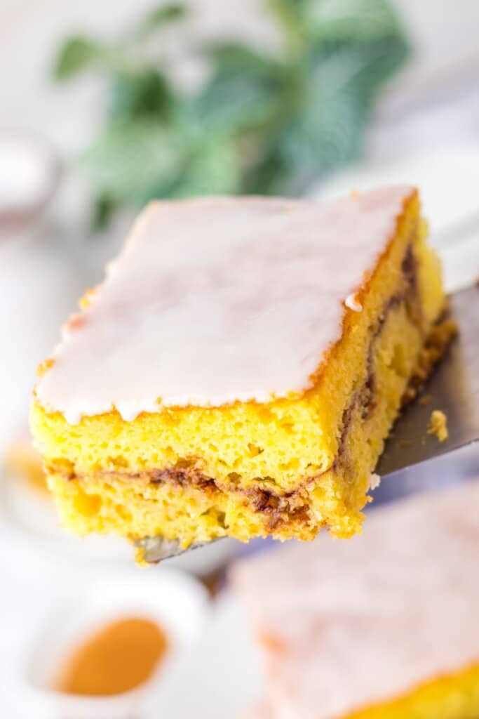 Slice of honey bun cake on a spatula.