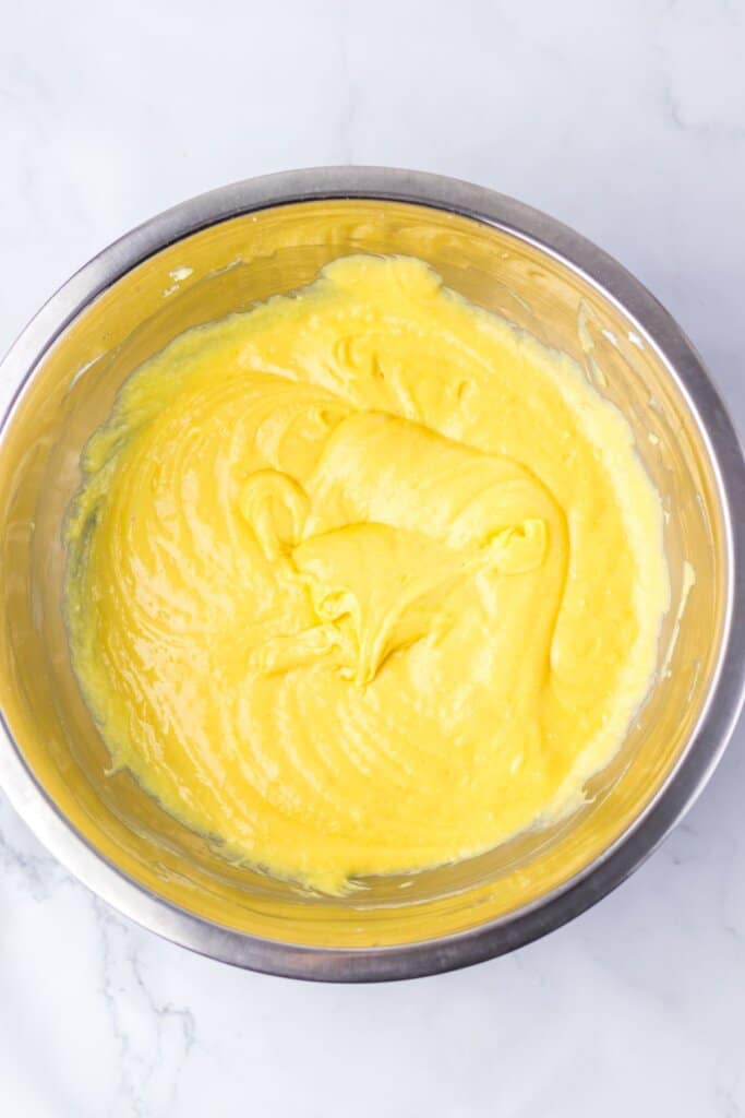 Cake batter in a stainless steel mixing bowl.