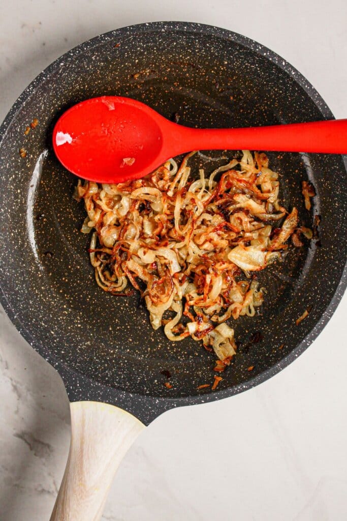Onions being cooked in a skillet.
