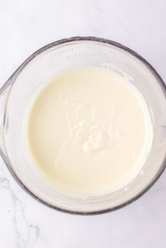 White chocolate melted in a glass mixing bowl.