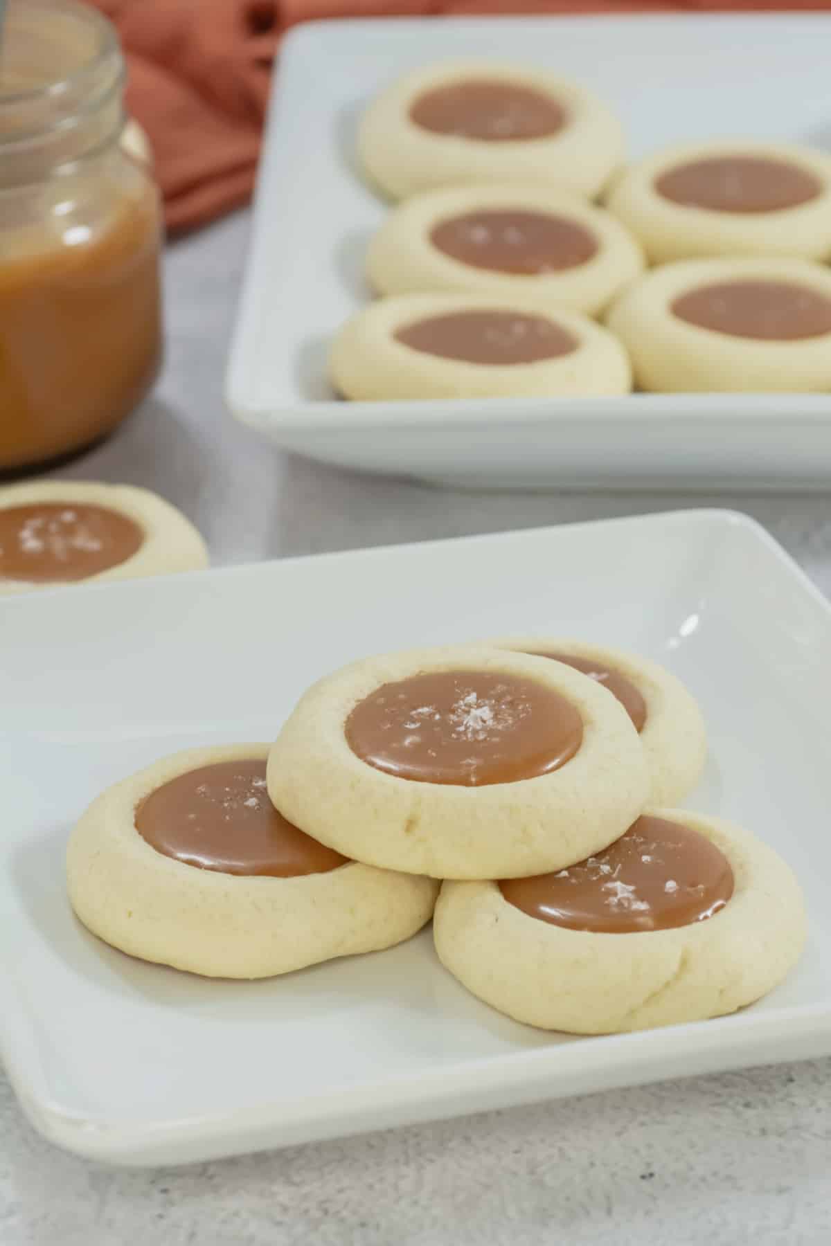Salted caramel cookies on a white plate.