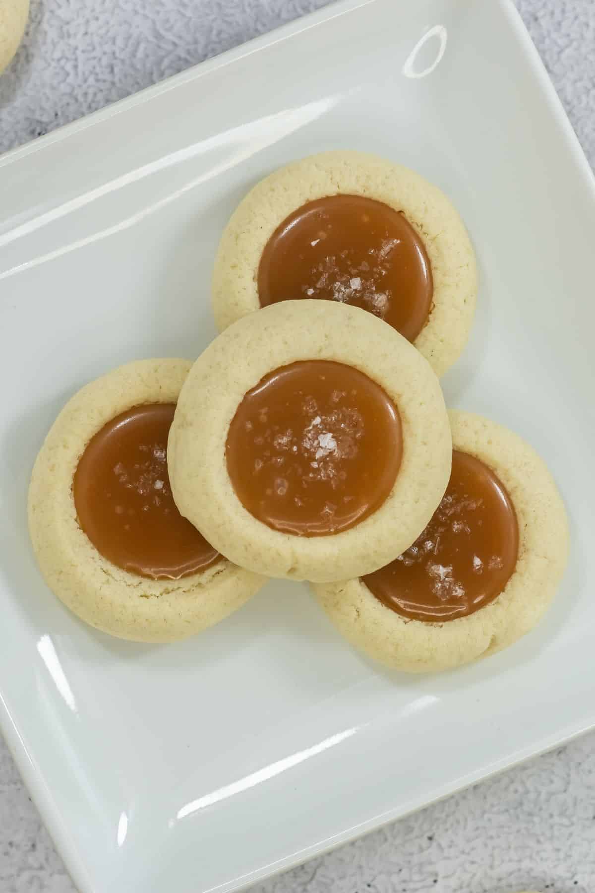 Salted caramel cookies on a white plate.