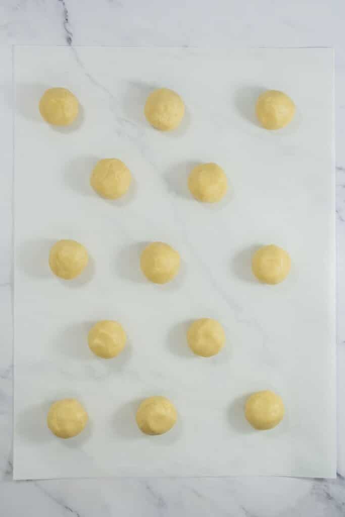 Dough balls on parchment paper.