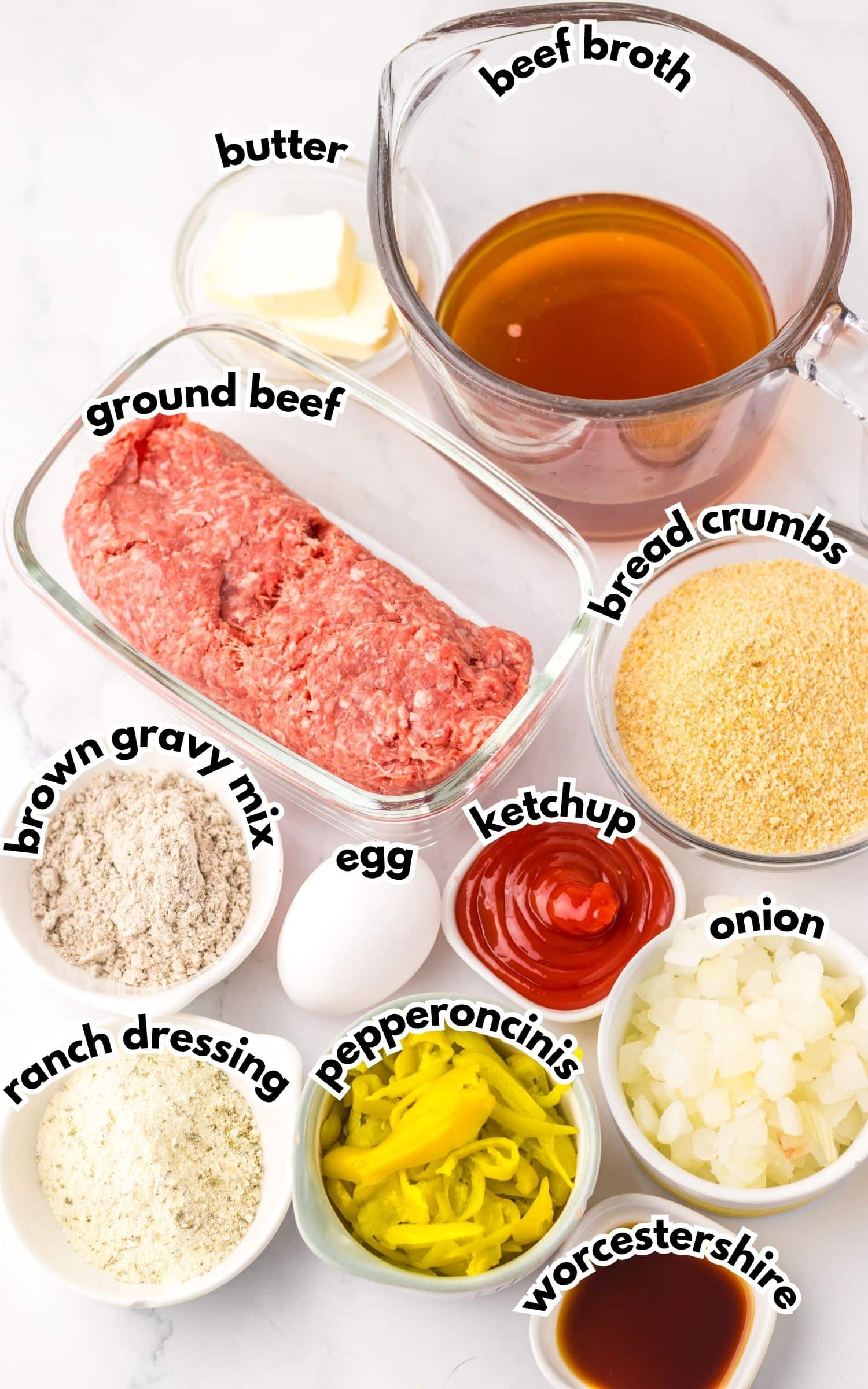 Bowls of ingredients labelled with text on a counter ready to cook.