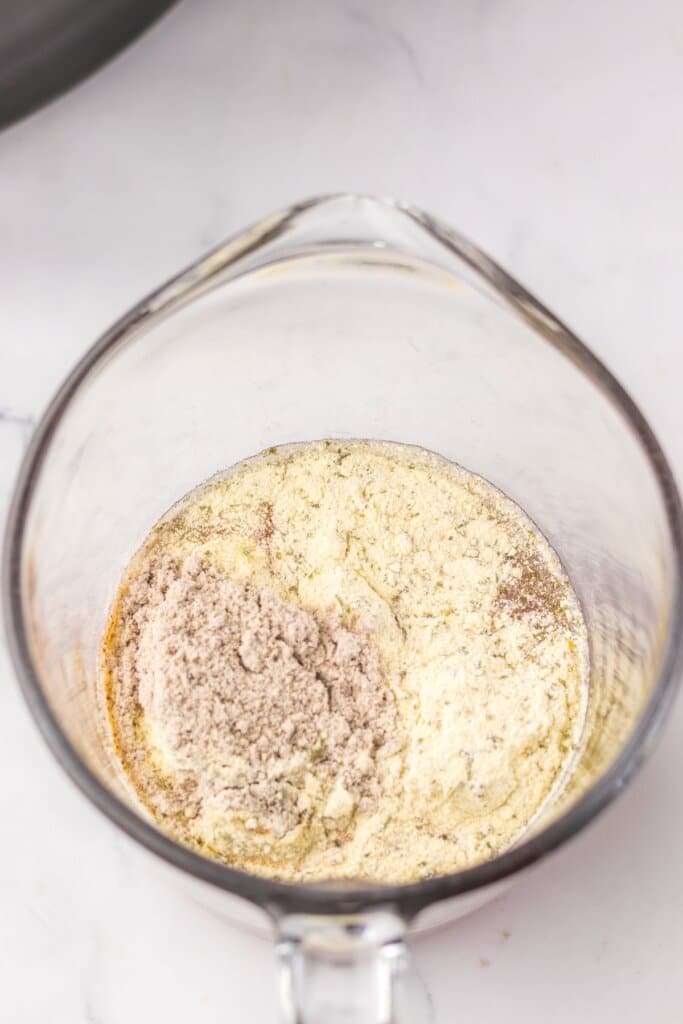 Gravy being mixed in a glass bowl.
