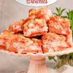 Strawberry brownies stacked on a white plate.