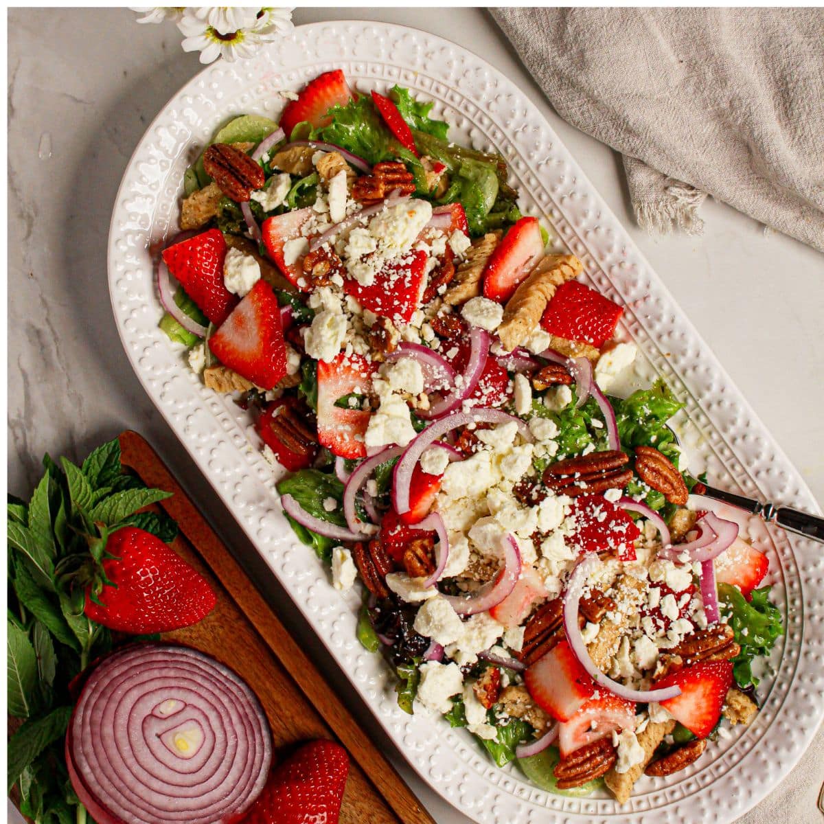 Platter full of strawberry fields salad.