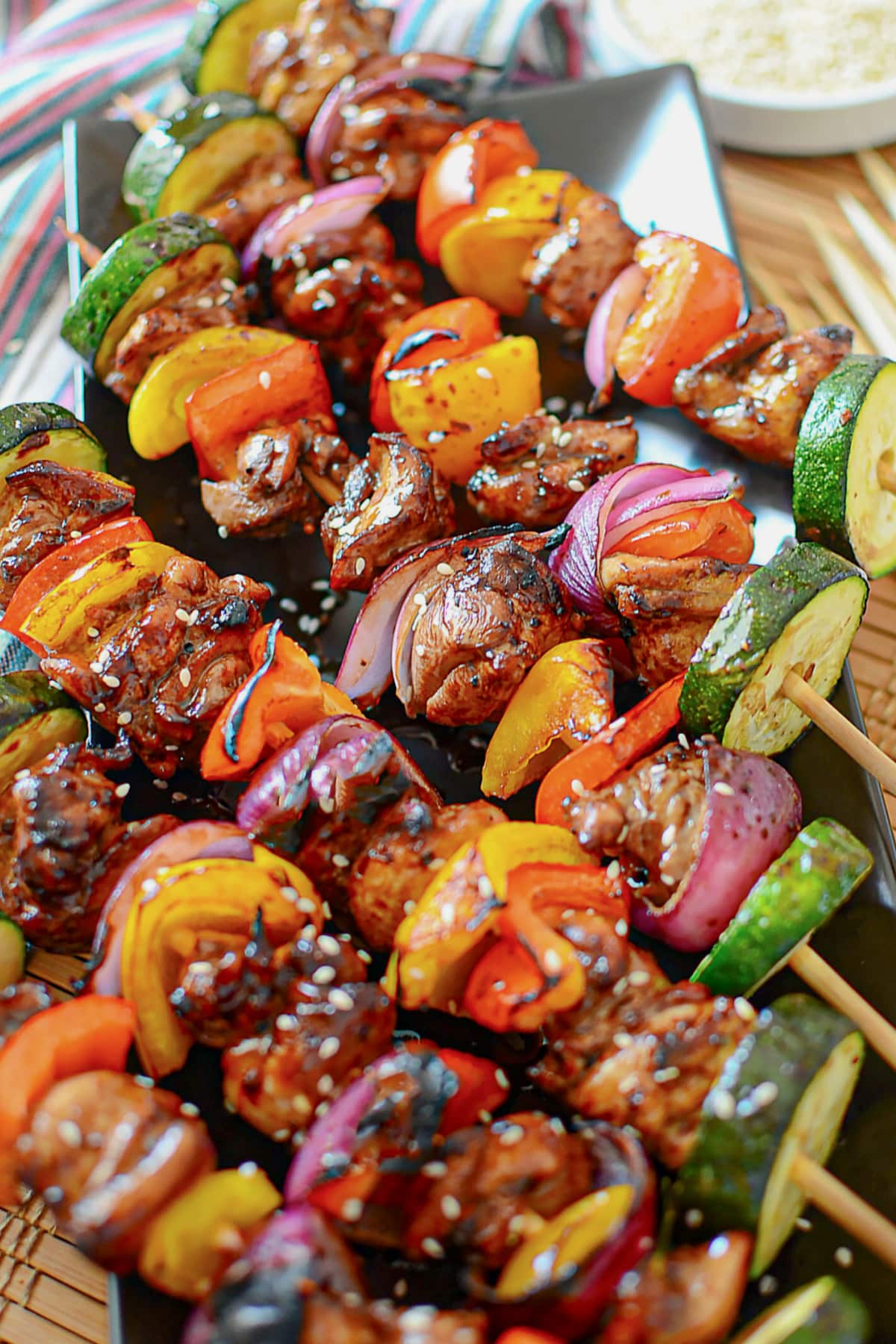 Asian chicken kabobs on a serving platter.
