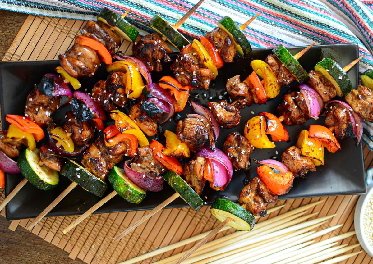 Asian chicken kabobs on a serving platter.