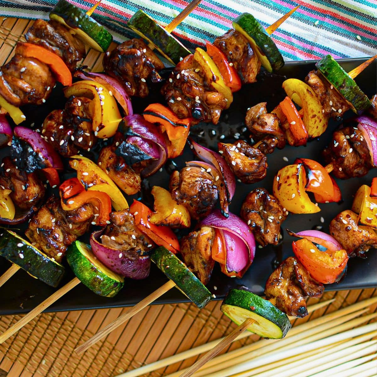 Asian chicken kabobs on a serving platter.