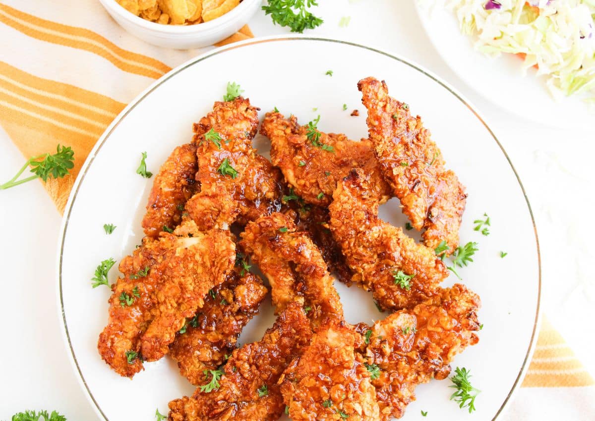 Bbq chicken tenders on a white plate.