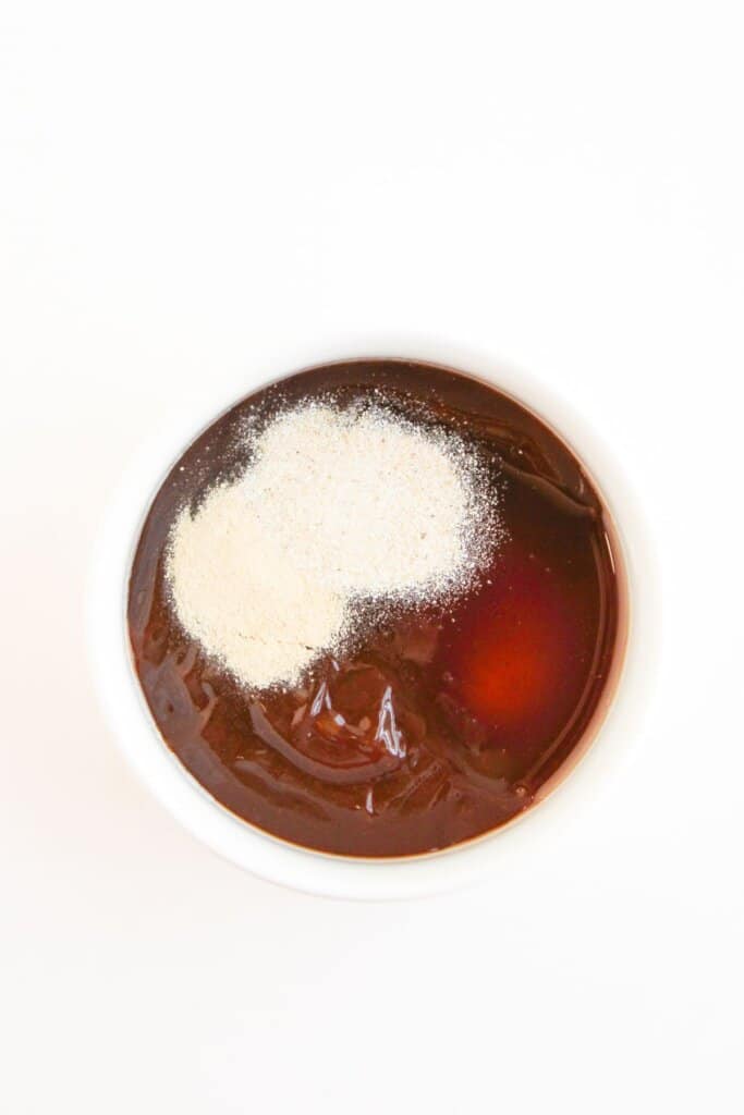 Sauce being mixed in a glass bowl.