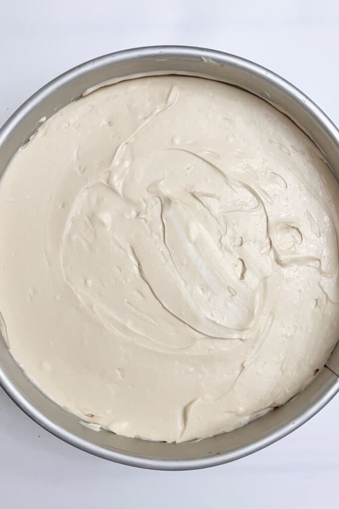Batter being spread in a springform pan.