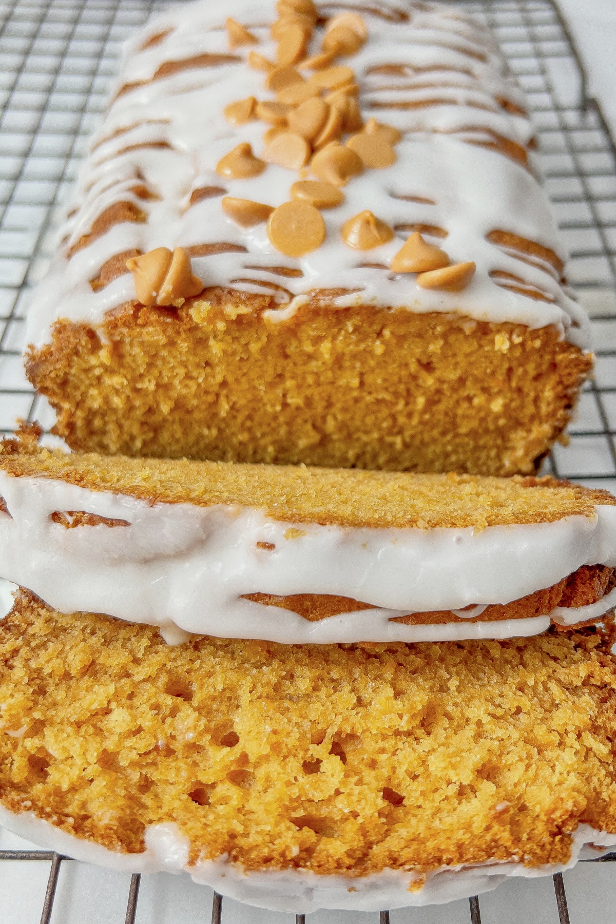 Slices of butterscotch pudding bread on a wire rack.