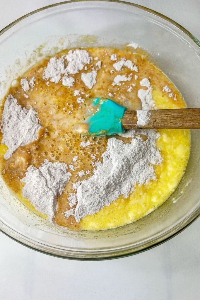 Batter being mixed in a glass mixing bowl.