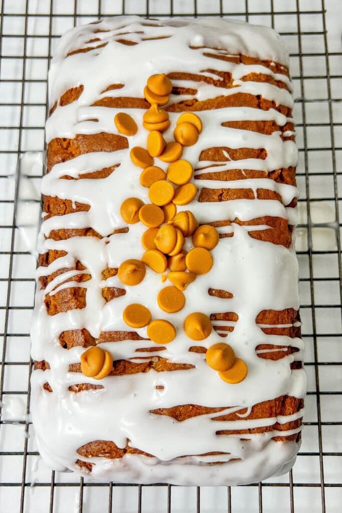 Loaf of butterscotch pudding bread on a wire rack.