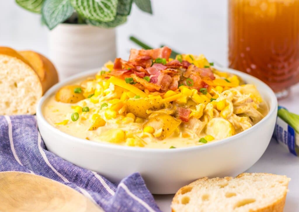 White bowl of chicken corn chowder. 
