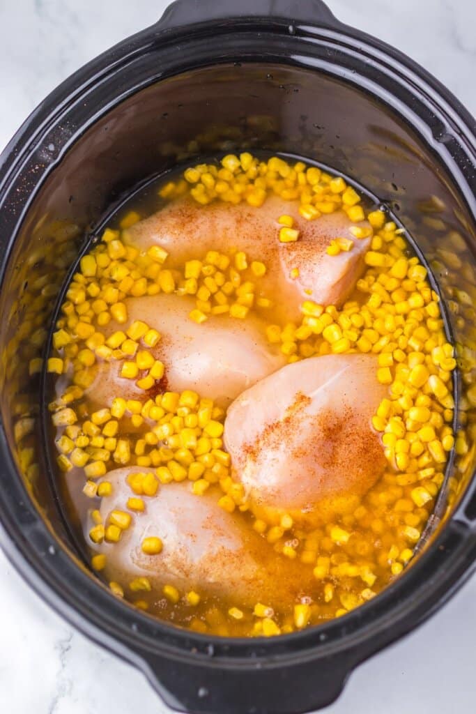 Broth being added to a crockpot.