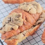 Chocolate chip cookie croissants on a wire cooling rack.