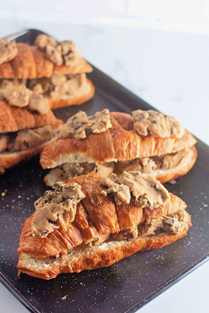 Dough on top of baked goods on a platter.