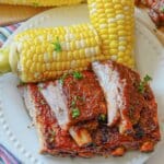 Ribs on a plate with corn on the cob.