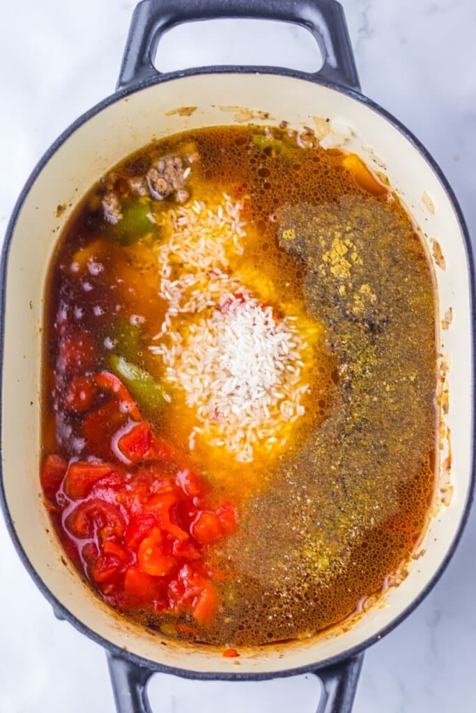 Ingredients being added to an oval pot. 