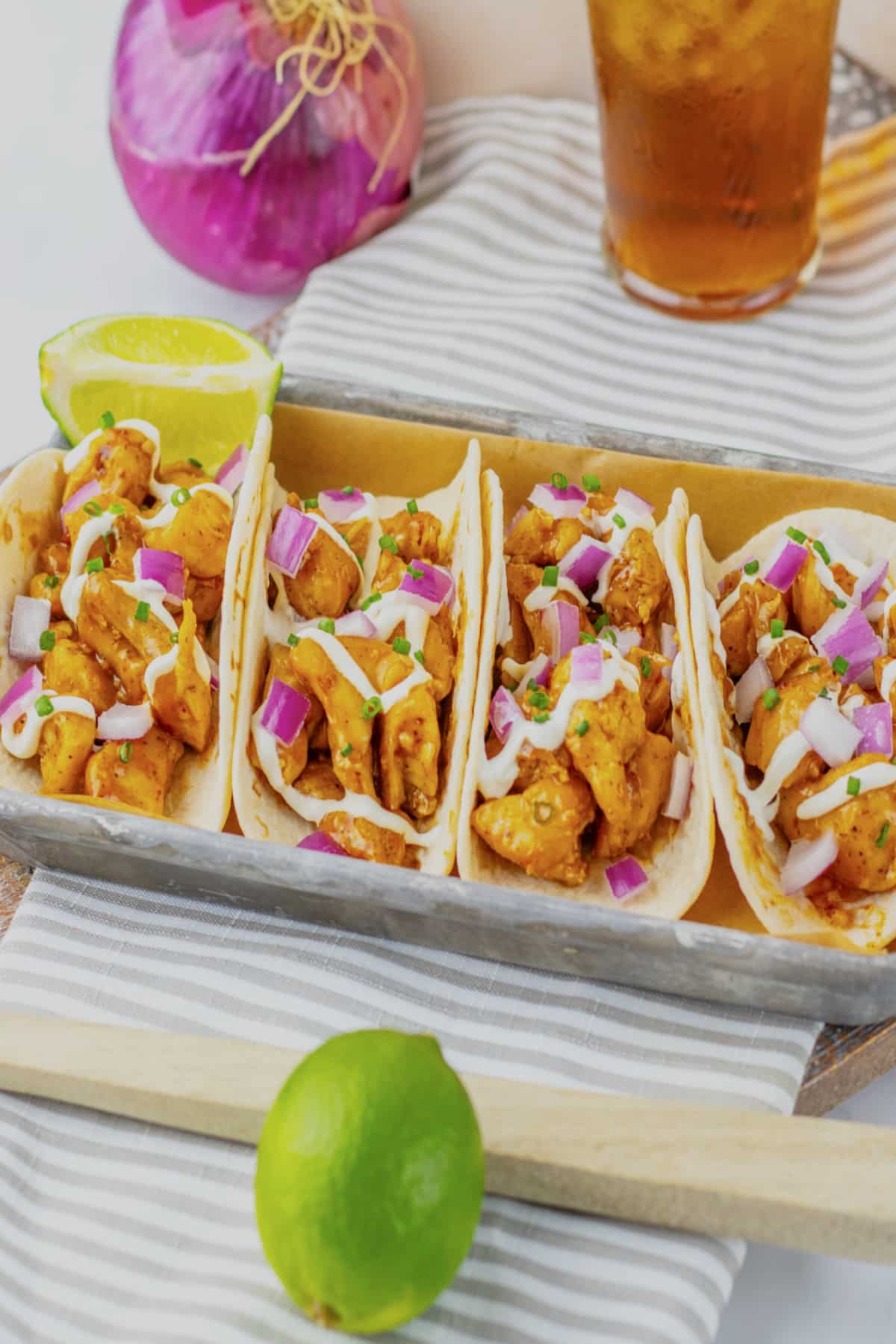 Garlic honey bbq chicken tacos on a metal serving tray.