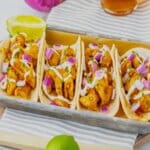 Garlic honey bbq chicken tacos on a metal serving tray.