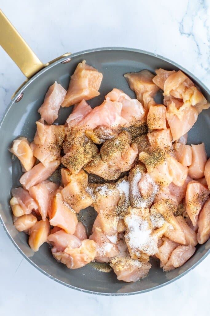 Meat being cooked in a skillet.