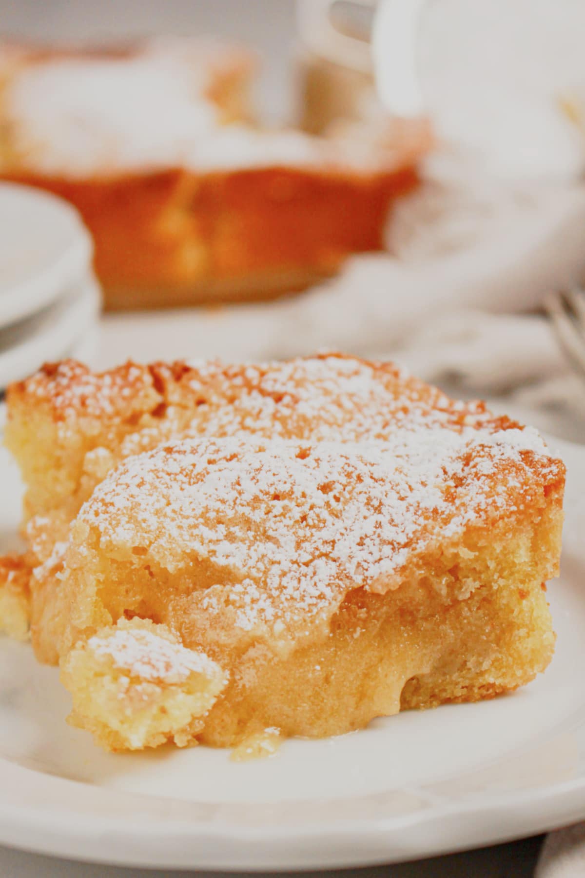 Slice of gooey butter coffee cake on a small plate.