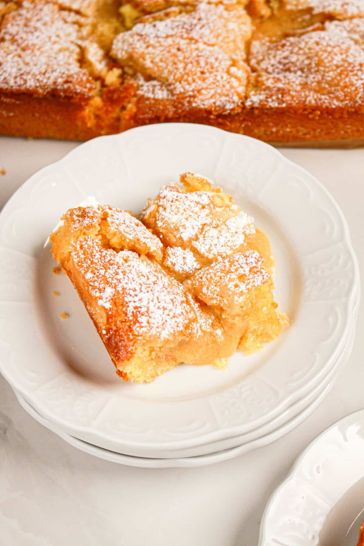 Slice of gooey butter coffee cake on a small plate.