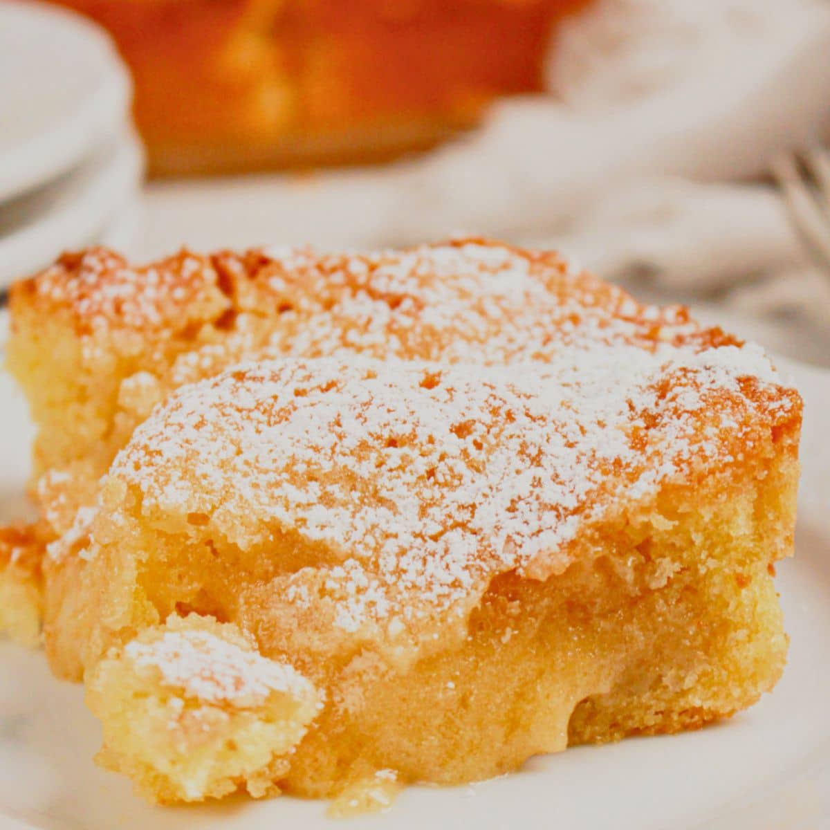 Slice of gooey butter coffee cake on a small plate.