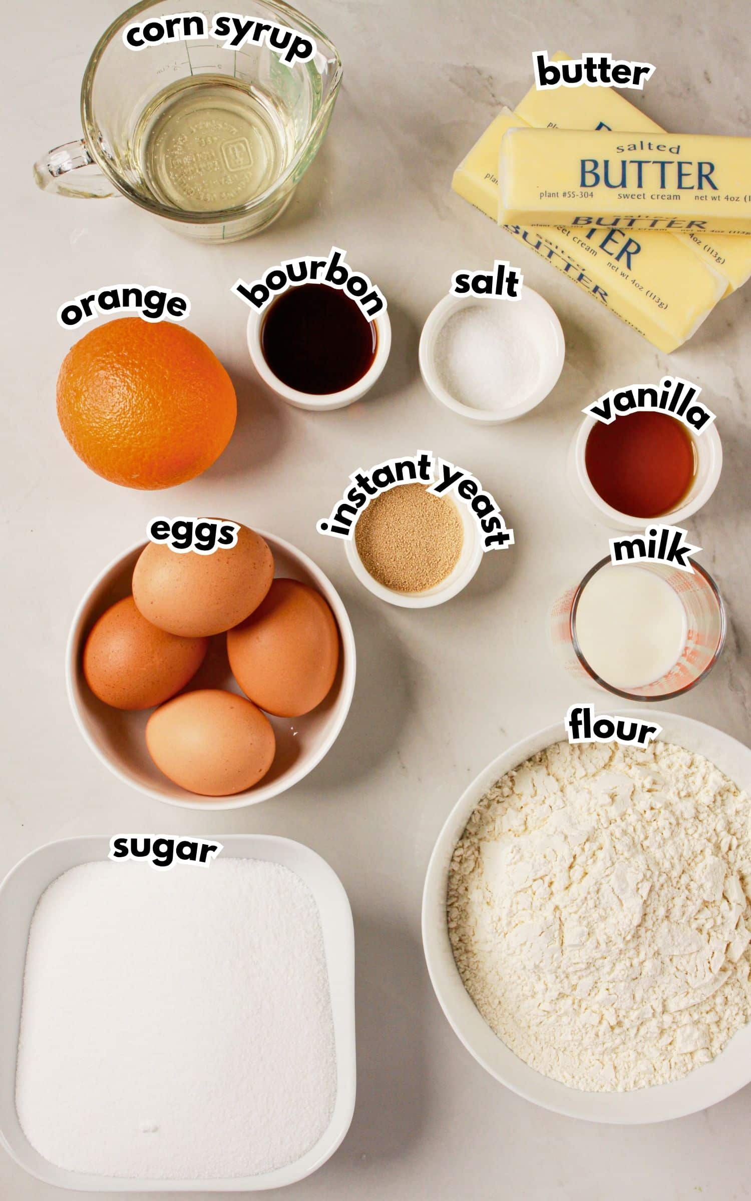 Bowls of ingredients labelled with text on a counter.