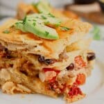 Slice of ground beef enchilada casserole on a small plate.