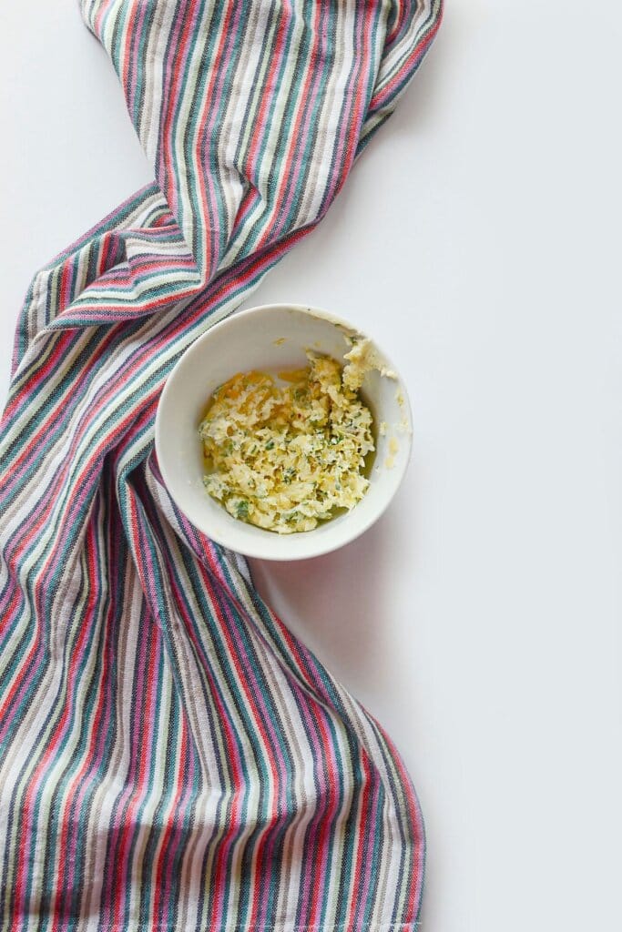 Small white bowl filled with garlic butter.