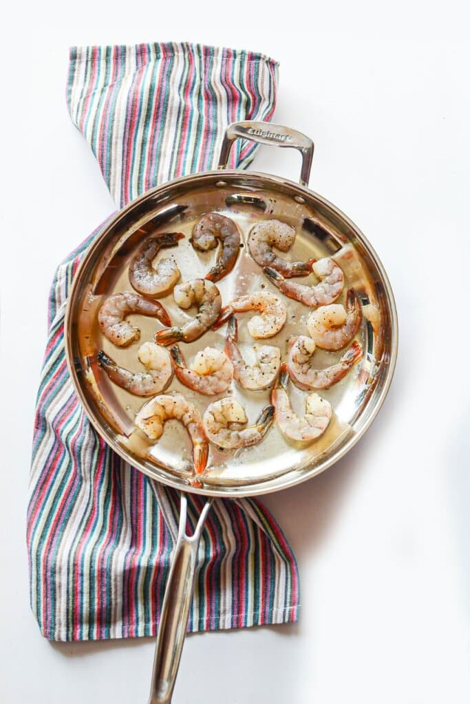 Shrimp being cooked in a skillet.