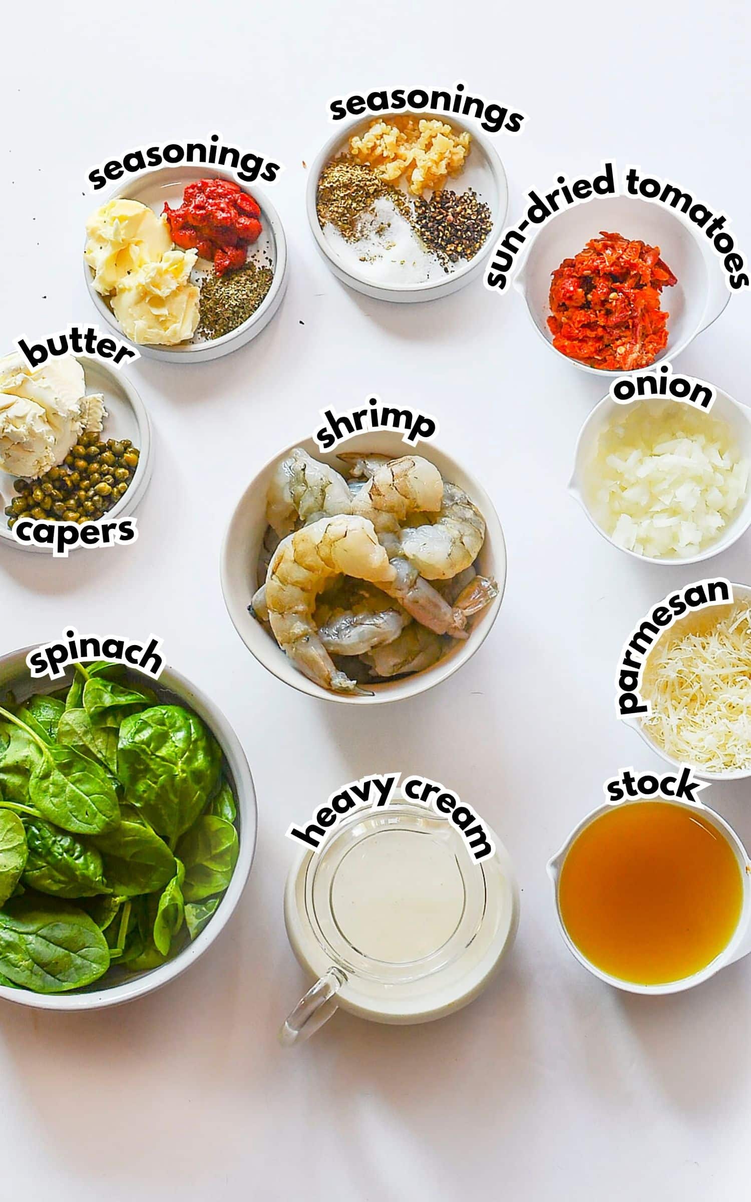 Bowls of ingredients labelled with text on a counter.