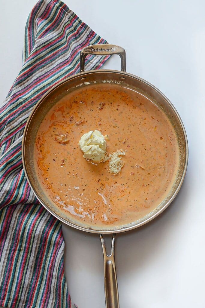 Cream sauce in a stainless steel pot.